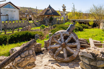 Obraz premium Decorative wheel, rustic symbol of progress. Background with selective focus and copy space