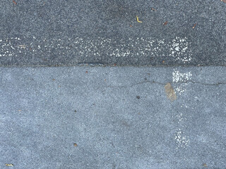 Asphalt mit ausgeblichener weißer Linie