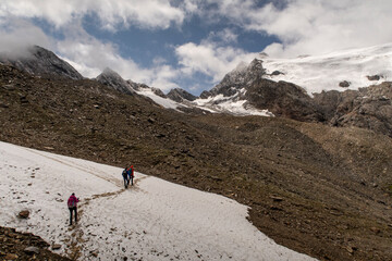 People hiking in the high mountains in the Alps