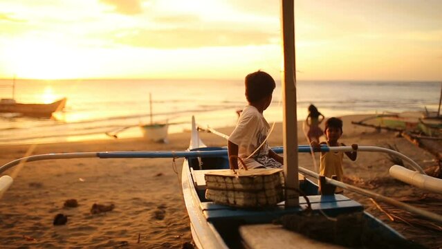 Asian Children Playing on a Tropical Sunset Beach, Philippines.