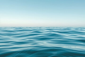 a flat and smooth water wave with blue sky over it