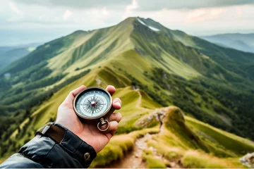 Foto op Canvas Hand holding a compass with a beautiful mountain landscape in the background, reflecting a sense of adventure and navigation. © apratim