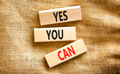Motivational and Yes you can symbol. Concept words Yes you can on beautiful wooden blocks. Beautiful canvas table canvas background. Business motivational and Yes you can concept. Copy space.