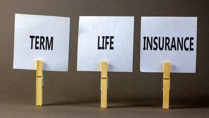 Term life insurance symbol. Concept words Term life insurance on beautiful white paper on clothespin. Beautiful grey table grey background. Business and term life insurance concept. Copy space.