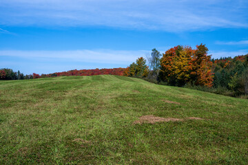 A freshly cut hay field in the Quebec fall colors