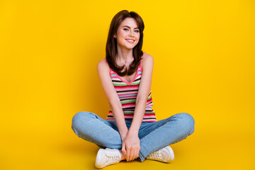 Full body photo of nice good mood girl wear striped tank denim trousers sitting on floor isolated...