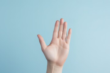 A hand gesture in front of a blue background