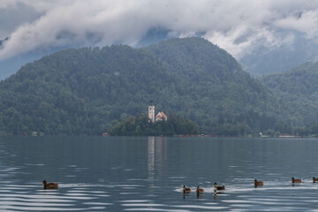 Lake Bled Slovenia. Beautiful mountain lake with small Pilgrimage Church. Most famous Slovenian lake and island Bled with Pilgrimage Church of the Assumption of Maria and Bled Castle in background.
