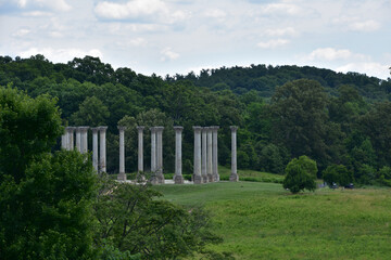 Fototapeta na wymiar Stone Columns in a Lush Green Landscape