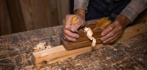 Carpenter's work. Carpentry tool. Hand plane. Old tools. Joinery tool. Wood shavings, chip. Carpenter working with wood	
