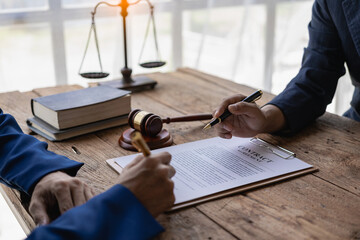 Attorneys work with clients in the office and speak with clients to discuss legal details. Close-up...