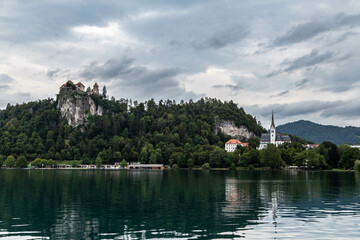 Lake Bled Slovenia. Beautiful mountain lake with small Pilgrimage Church. Most famous Slovenian lake and island Bled with Pilgrimage Church of the Assumption of Maria and Bled Castle in background.