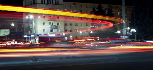 A photo using a slow shutter speed to capture the lights on a highway.