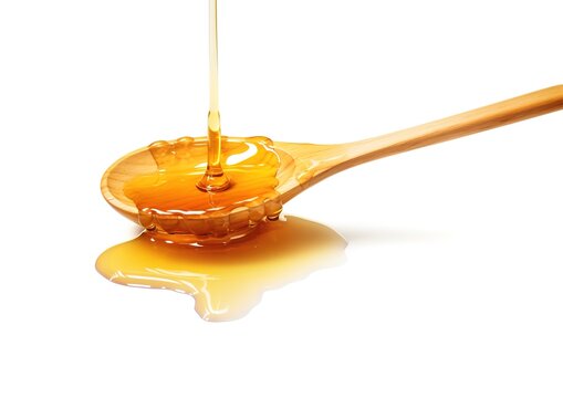 a spoon with melted sweet honey on an white background. Can be used as a promotional background for your honey products.