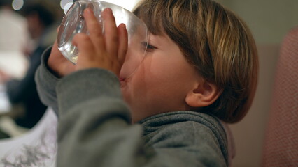 Child Quenching Thirst with Water After Meal - Hydration at Restaurant