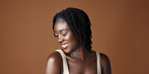 Face, beauty and aesthetic with funny black woman in studio isolated on brown background for...