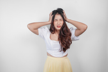 A sad Asian woman looks stressed and depressed, isolated white background.