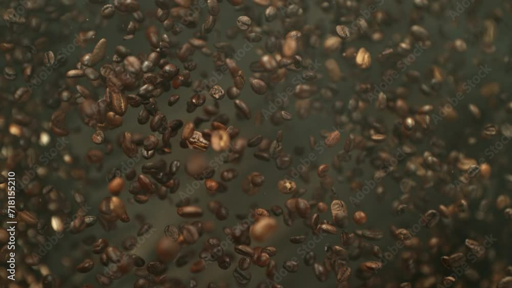 Poster super slow motion of flying coffee beans isolated on dark background. macro shot. filmed on high spe