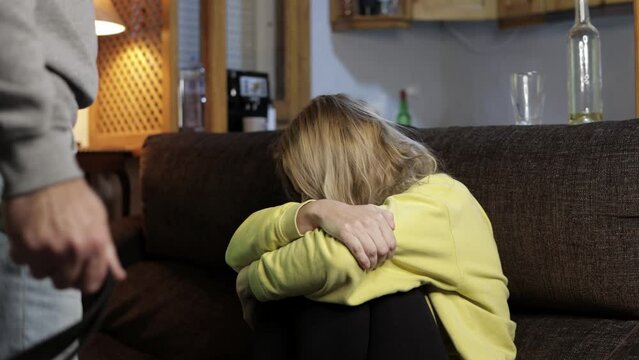 Domestic violence,frightened woman victim abused by man alcoholic,scared wife sitting in living room