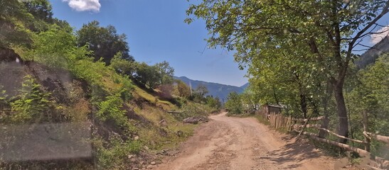 Fototapeta na wymiar dirty road throught mountain pass in georgia