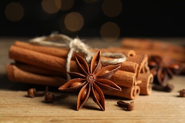 Different aromatic spices on wooden table, closeup