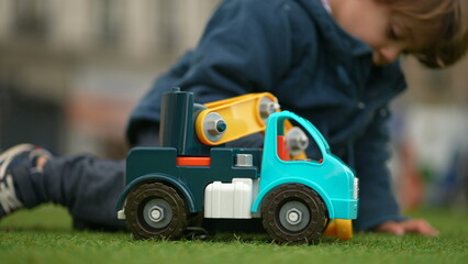 Young Kid Engrossed in Excavator Play at Park - Child with Toy Claw in Autumn Season
