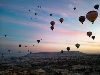 Hot air balloon flight in Goreme in Turkey during sunrise. Ride in a hot air balloon, the most popular activity in Cappadocia. Romantic and famous travel destination.