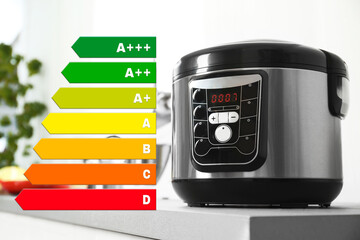 Energy efficiency rating label and multi cooker on table indoors