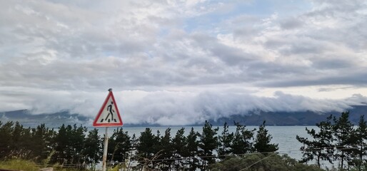 lake sevan in armenia and clouds falling over the mountains