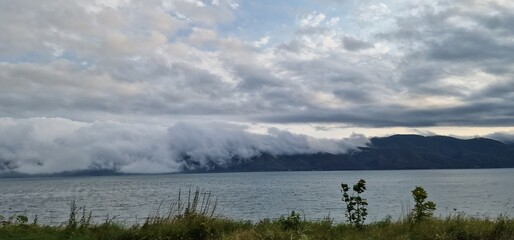 lake sevan in armenia and clouds falling over the mountains