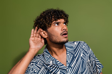 Photo of shocked confused man touch ear listen gossips about himself in secret dialogue look...