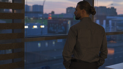 Pensive thoughtful male investor city developer businessman at evening office thinking problem...
