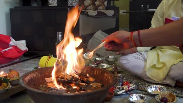 Cinematic footage of Havan or Yagya , a Hindu ritual of offering substances to a holy fire while chanting mantras.Uttarakhand India