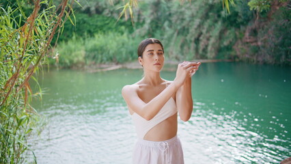 Fototapeta premium Tender lady stretching hands tropics closeup. Dancer warming before performance