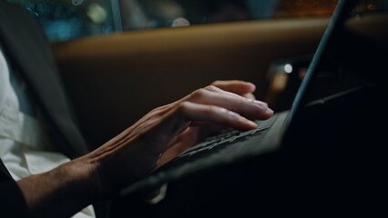 Man fingers typing computer keyboard vehicle closeup. Specialist working tablet