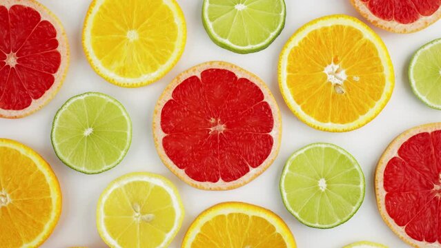 Sliced fresh citrus fruits grapefruit, orange, lemon, lime, kiwi rotate turn isolated white background close up for your top view design. Healthy fruit. Summer fresh fruit snack concept. Vitamin C