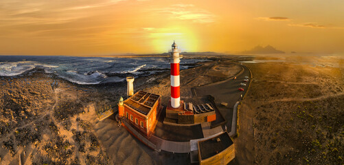 scenic  landscape with lighthouse over sunset. aerial drone view, Fuerteventura . Canary island, El...