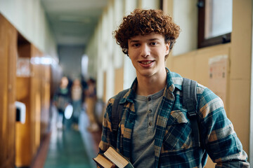 Portrait of high school student in hallway looking at camera.