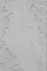Vertical photo of plaster on the wall.