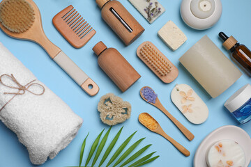 Flat lay composition with different spa products on light blue background