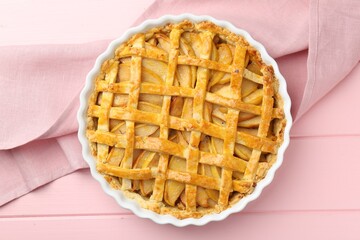Tasty homemade quince pie on pink wooden table, top view