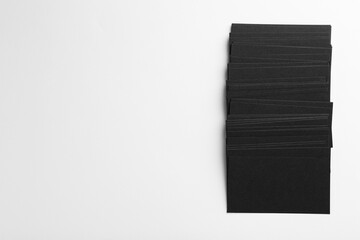 Blank black business cards on white background, top view. Mockup for design