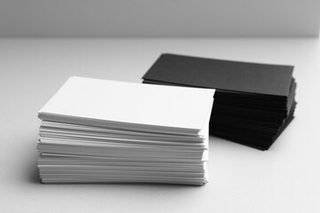 Blank business cards on white background, closeup. Mockup for design