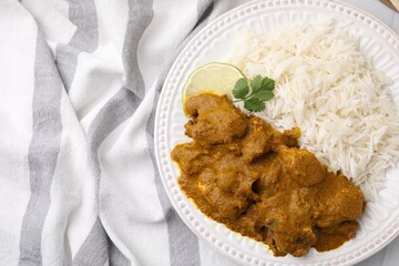 Delicious chicken curry with rice on table, top view
