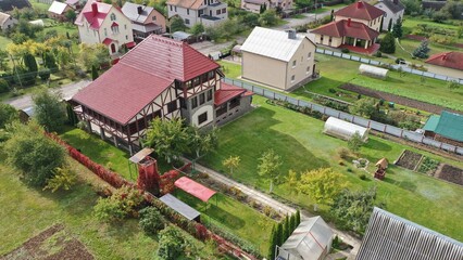 A typical cottage country village in Europe with private houses, grounds, vegetable gardens for...