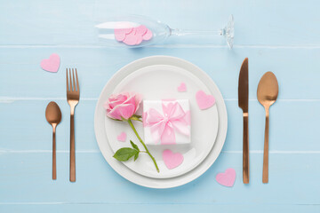 Festive table setting for Valentine's Day on wooden background, top view