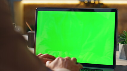 Businessman hands typing green screen laptop in office closeup. Manager working