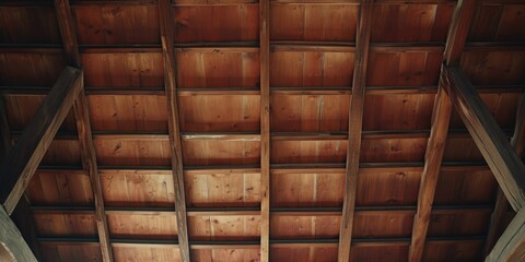 A picture of the ceiling inside a barn, showcasing the beautiful wooden beams. Suitable for rustic and agricultural themes