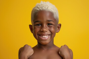 A young boy with white hair happily smiles while flexing his muscles. This image can be used to portray confidence, strength, and positivity in various contexts - Powered by Adobe