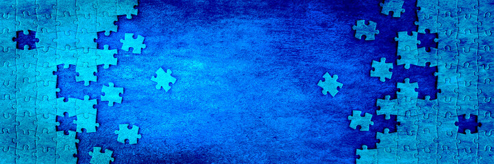 Jigsaw puzzle pieces with copy space on dark blue banner background